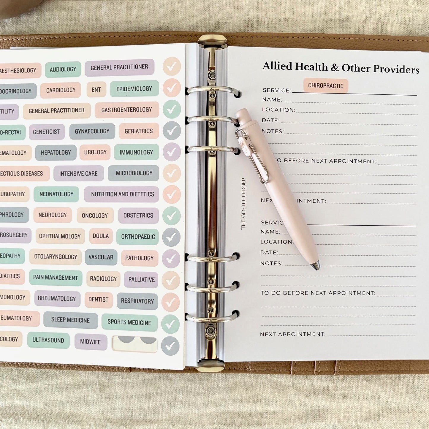 Open planner with Allied Health providers section and a pen on a beige surface