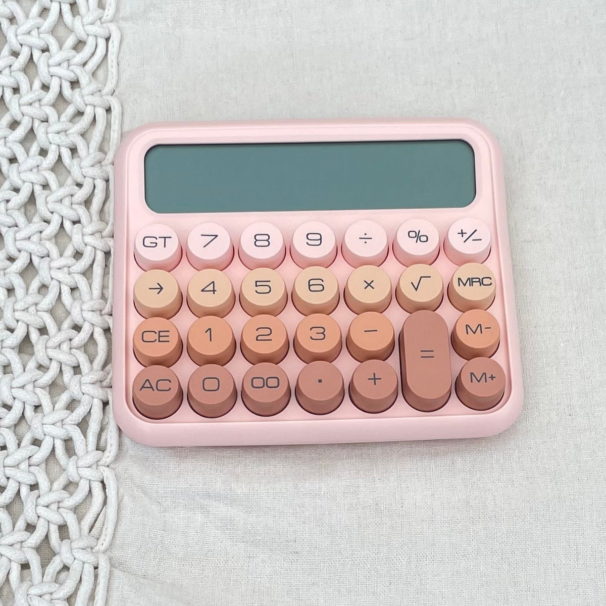 pink calculator on beige background