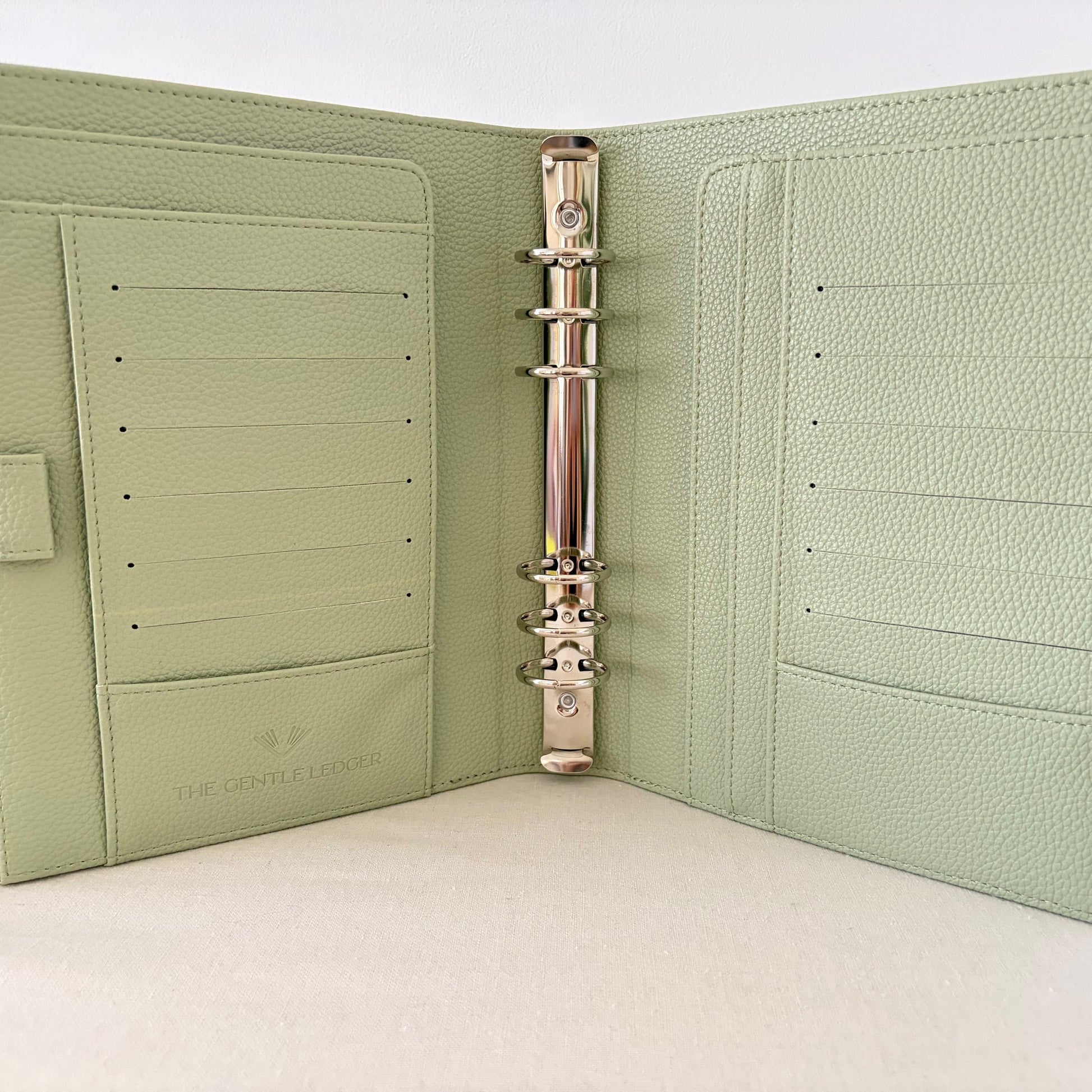 Sage green vegan pebble leather 6 ring binder on a white background